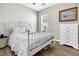 Bright bedroom with wood floors, featuring white metal bed frame and a dresser at 174 Sea Lavender Ln, Summerville, SC 29486