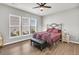 Comfortable bedroom with abundant natural light from multiple windows and a ceiling fan at 174 Sea Lavender Ln, Summerville, SC 29486