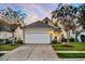 Charming single-story home boasts a manicured front lawn, two-car garage, and inviting curb appeal at 174 Sea Lavender Ln, Summerville, SC 29486