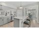 Open kitchen with island, gray cabinets, stainless appliances, and seating, perfect for casual dining and entertaining at 174 Sea Lavender Ln, Summerville, SC 29486
