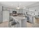 Bright kitchen features gray cabinets, stainless steel appliances, mosaic backsplash and a center island with seating at 174 Sea Lavender Ln, Summerville, SC 29486