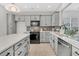 Well-equipped kitchen with gray cabinetry, stainless steel appliances, and ample counter space, ideal for cooking and entertaining at 174 Sea Lavender Ln, Summerville, SC 29486