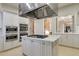 This kitchen features white cabinetry, stainless steel appliances, and a center island cooktop for a sleek design at 174 Sea Lavender Ln, Summerville, SC 29486