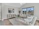 Bright living room with vaulted ceiling, plush sofas, and large windows overlooking a tranquil water view at 174 Sea Lavender Ln, Summerville, SC 29486