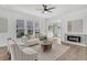 Airy living room featuring a cozy fireplace, lots of natural light, and contemporary decor throughout the space at 174 Sea Lavender Ln, Summerville, SC 29486