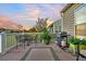 Back patio with dining set, barbecue grill, landscaped greenery and sunset views at 174 Sea Lavender Ln, Summerville, SC 29486