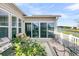 Outdoor patio with seating, grill, and scenic water views overlooking the tranquil pond and blue sky at 174 Sea Lavender Ln, Summerville, SC 29486