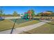 Community playground with slides, swings, and picnic tables under an umbrella on a sunny day at 174 Sea Lavender Ln, Summerville, SC 29486