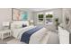 Serene bedroom with lots of natural light, a large bed, and an eye-catching painting on the wall at 1844 Nola Run, Summerville, SC 29485