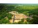 Aerial view of land, showcasing roads and pond at 201 Seele St, Lincolnville, SC 29485