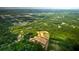 Aerial view of land, showing green foliage, roads, and pond at 201 Seele St, Lincolnville, SC 29485