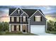Charming two-story home with gray siding, black shutters, and a well-manicured lawn at 201 Seele St, Lincolnville, SC 29485