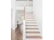 Elegant staircase with wooden steps and white railings leading to the second floor at 201 Seele St, Lincolnville, SC 29485