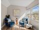 Sun-drenched sitting room featuring two plush blue armchairs, natural lighting, and wood flooring at 2028 Wild Flower Lane, Charleston, SC 29414