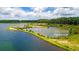 Scenic aerial view of a lake bordered by lush green forests and grassy banks under a partly cloudy sky at 207 Calm Water Way, Summerville, SC 29486