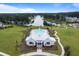 Aerial view of clubhouse and pool overlooking a lake surrounded by lush trees at 207 Calm Water Way, Summerville, SC 29486