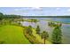 Expansive lake with well-maintained green landscapes, palm trees, and shrubbery, showcasing natural beauty at 207 Calm Water Way, Summerville, SC 29486