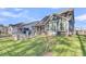 Exterior view of the house highlighting a backyard with firepit, seating, and a screened-in porch at 207 Calm Water Way, Summerville, SC 29486