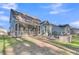 Inviting backyard with screened porch and brick fire pit seating area, perfect for outdoor relaxation at 207 Calm Water Way, Summerville, SC 29486