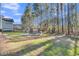Beautiful backyard featuring a stone fire pit surrounded by seating, with a view of towering pine trees at 207 Calm Water Way, Summerville, SC 29486