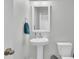Bright bathroom with a pedestal sink, white fixtures, and a framed mirror at 207 Calm Water Way, Summerville, SC 29486