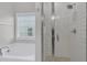 Bathroom with a soaking tub beside a tiled shower, enhanced by natural light from a nearby window at 207 Calm Water Way, Summerville, SC 29486