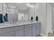 Bathroom with a double sink vanity and well-lit mirror, complemented by a sleek, modern glass shower at 207 Calm Water Way, Summerville, SC 29486