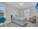 Cozy bedroom featuring a colorful quilt, comfortable chair, and bright natural light at 207 Calm Water Way, Summerville, SC 29486