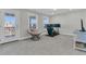 Bonus room with a chair, TV setup, and a door leading to a balcony at 207 Calm Water Way, Summerville, SC 29486