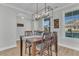 Charming dining room featuring wood floors, a stylish light fixture, and a view of the neighborhood at 207 Calm Water Way, Summerville, SC 29486