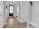 Hallway with light colored wood floors and trim with views into adjoining rooms at 207 Calm Water Way, Summerville, SC 29486