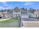 Lovely two-story home with a charming porch, inviting second-story balcony, and a two-car garage at 207 Calm Water Way, Summerville, SC 29486