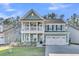 Charming two-story home with covered porch, second-story balcony, and two-car garage at 207 Calm Water Way, Summerville, SC 29486