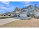 Stunning two-story home featuring a balcony, covered porch, a two-car garage, and a long driveway at 207 Calm Water Way, Summerville, SC 29486
