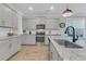 Modern kitchen with stainless appliances, granite countertops, white cabinets, and subway tile backsplash at 207 Calm Water Way, Summerville, SC 29486