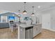 Open concept kitchen with a dining area and living room featuring a large island and stainless appliances at 207 Calm Water Way, Summerville, SC 29486