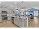 Open concept kitchen with granite counters, stainless appliances, dining area and living room beyond at 207 Calm Water Way, Summerville, SC 29486