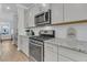 Modern kitchen with stainless steel gas range, granite countertops, and shaker style cabinetry at 207 Calm Water Way, Summerville, SC 29486
