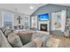 A spacious living room featuring shiplap walls, a fireplace, and plenty of natural light from large windows at 207 Calm Water Way, Summerville, SC 29486