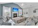 Open-concept living room features a fireplace, vaulted ceilings, and doors leading to the outdoor space at 207 Calm Water Way, Summerville, SC 29486