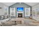 The living room boasts a fireplace, vaulted ceilings, and a large TV, creating a cozy and inviting atmosphere at 207 Calm Water Way, Summerville, SC 29486
