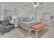 Bright main bedroom with neutral tones, complemented by a cozy chair and soft natural light at 207 Calm Water Way, Summerville, SC 29486