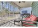 Inviting screened porch featuring comfortable seating and a view of the backyard at 207 Calm Water Way, Summerville, SC 29486