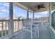 Covered front porch featuring a dining set with white railings and columns at 207 Calm Water Way, Summerville, SC 29486