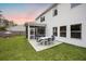 Well-maintained backyard featuring a screened porch, green lawn, and white siding at 217 Lucca Dr, Summerville, SC 29486