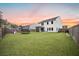 Expansive backyard with lush lawn, playground, trampoline, and a view of the home's exterior at 217 Lucca Dr, Summerville, SC 29486