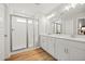 Modern bathroom featuring dual sinks, wood look tile floors, and a glass enclosed shower at 217 Lucca Dr, Summerville, SC 29486