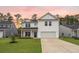 Charming two-story home with a well-manicured lawn, a two-car garage, and inviting curb appeal at 217 Lucca Dr, Summerville, SC 29486