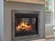 Fireplace with a gray mantle and a burning fire at 217 Lucca Dr, Summerville, SC 29486