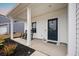 Inviting front porch with rocking chairs and a charming entrance door at 217 Lucca Dr, Summerville, SC 29486